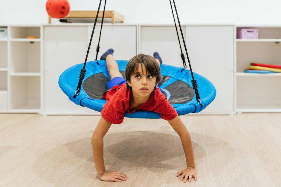 SkyClimb Method, child using therapeutic platform swing for vestibular sensory integration and proprioceptive input therapy